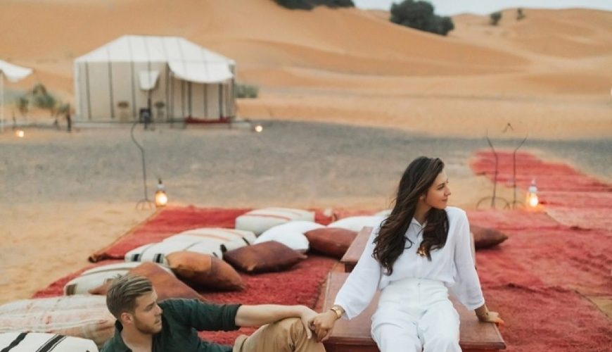 stylish-european-couple-in-love-enjoying-evening-together-in-luxury-glamping-camp-in-sahara-desert-.jpg