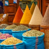 Busy Moroccan souk with tourists and vendors offering services – stay vigilant to avoid scams in Morocco