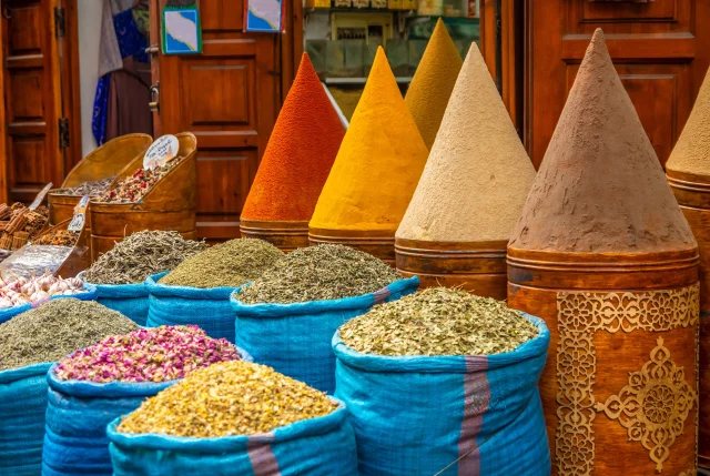 Busy Moroccan souk with tourists and vendors offering services – stay vigilant to avoid scams in Morocco