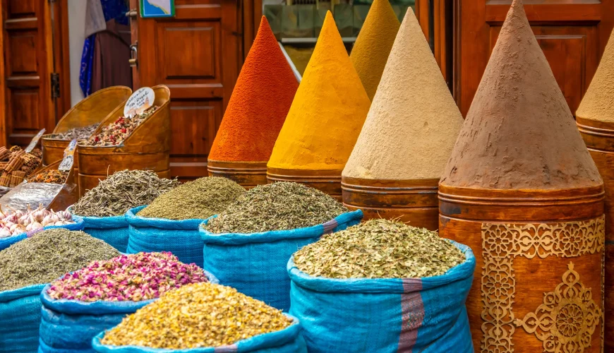 Busy Moroccan souk with tourists and vendors offering services – stay vigilant to avoid scams in Morocco